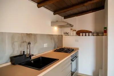 a kitchen with a sink and a stove at SKY DOMUS ROME Historic Center Penthouse With Jacuzzi in Rome