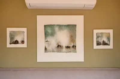 three framed paintings on a wall in a room at SKY DOMUS ROME Historic Center Penthouse With Jacuzzi in Rome