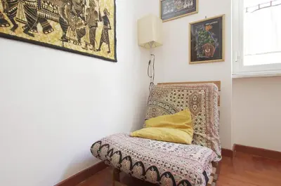 a chair with a pillow on it in a room at La Casa dei Quattro Venti in Rome