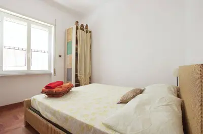 a bedroom with a bed and a window at La Casa dei Quattro Venti in Rome