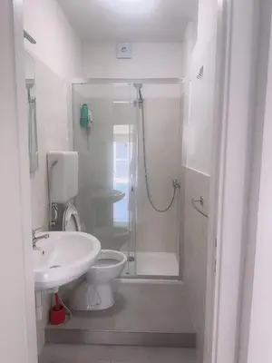 a bathroom with a shower and a toilet and a sink at Lisa HOUSE in Rome