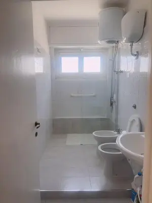 a white bathroom with a toilet and a sink at Lisa HOUSE in Rome