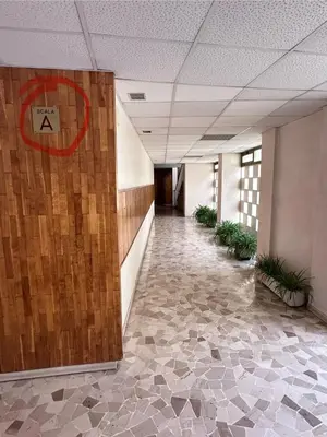 a hallway in an office building with a sign on the wall at Lisa HOUSE in Rome