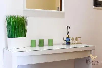 a shelf in a room with green art on it at MrBrown - Pincherle Room in Rome