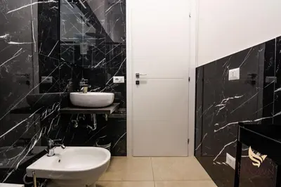 a bathroom with a sink and a white toilet at MrBrown - Pincherle Room in Rome