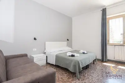 a bedroom with a bed and a couch at MrBrown - Pincherle Room in Rome