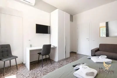 a bedroom with a bed and a desk and a couch at MrBrown - Pincherle Room in Rome