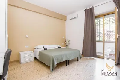 a bedroom with a bed and a window at MrBrown - Pincherle Room in Rome