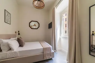 a bedroom with a bed and a window at Casa Enea - Pretty Homes in Rome