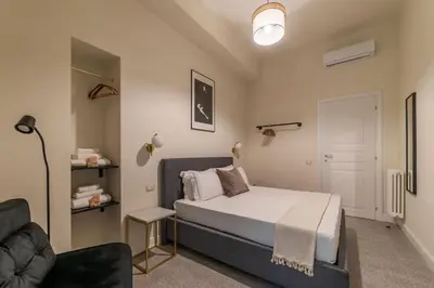 a bedroom with a bed and a couch at Casa Enea - Pretty Homes in Rome