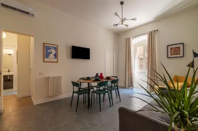 a living room with a table and chairs at Casa Enea - Pretty Homes in Rome