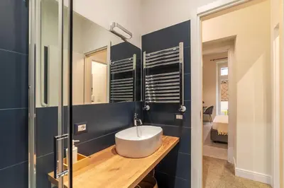 a bathroom with a sink and a mirror at Casa Enea - Pretty Homes in Rome