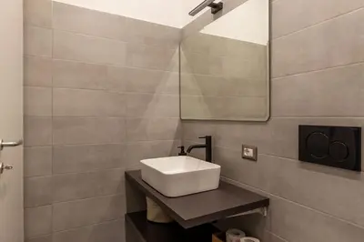 a bathroom with a sink and a mirror at Casa Enea - Pretty Homes in Rome
