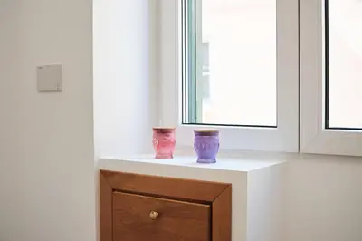 two vases sitting on a counter next to a window at 20 Minuti Vaticano - Nido Romano Shopping Folkoristico by Hôtea in Rome