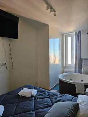 a bedroom with a bed and a bath tub at Vatican Jacuzzi House in Rome