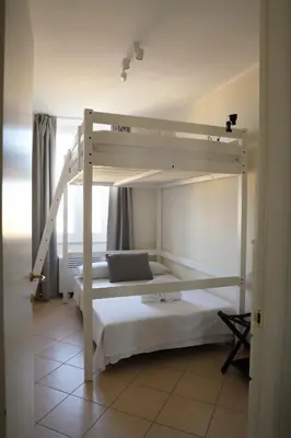 a bedroom with two bunk beds and a ladder at Vatican Jacuzzi House in Rome