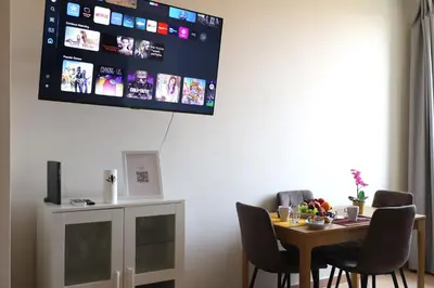 a room with a table with chairs and a tv on the wall at Vatican Jacuzzi House in Rome