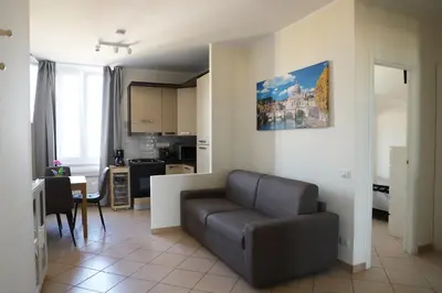 a living room with a couch and a kitchen at Vatican Jacuzzi House in Rome