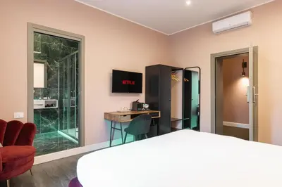 a room with a bed and a desk and a window at My Rooms in Vatican City in Rome