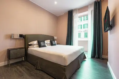 a bedroom with a large bed and a large window at My Rooms in Vatican City in Rome