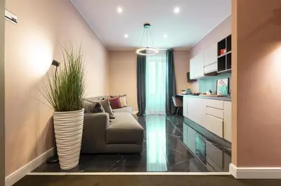 a living room with a couch and a vase with a plant at My Rooms in Vatican City in Rome