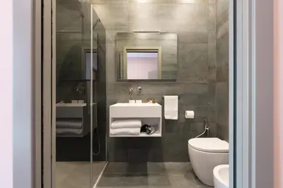 a bathroom with a sink and a toilet and a mirror at My Rooms in Vatican City in Rome