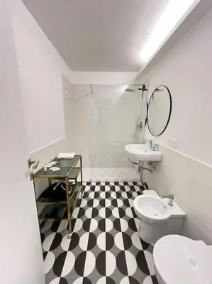 a bathroom with a black and white checkered floor at EppyTime Roma in Rome