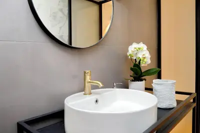 a bathroom with a white sink and a mirror at EVE Guest House at Trevi Fountain in Rome