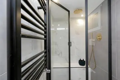 a shower with a glass door in a bathroom at EVE Guest House at Trevi Fountain in Rome