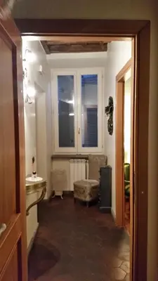 a hallway with a room with a sink and a window at Diapason Colosseo Suite in Rome