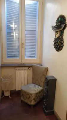 a room with a chair and a hat on the wall at Diapason Colosseo Suite in Rome