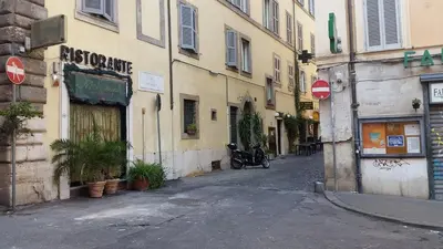 an alley with a building and a motorcycle parked next to it at Diapason Colosseo Suite in Rome
