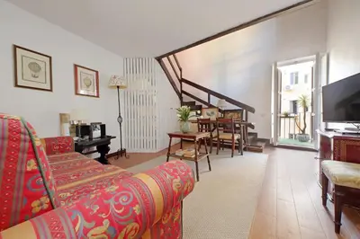 a living room with a couch and a dining room at Leonina Terrace - My Extra Home in Rome