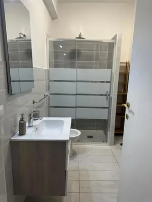 a bathroom with a sink and a shower and a toilet at Alloggio turistico Gloria in Rome