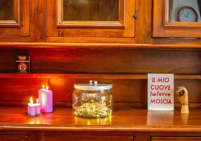 a jar with lights and candles on a counter with a sign at Luminoso a due passi da Piazza Bologna in Rome