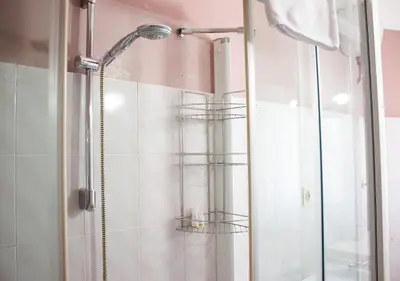 a bathroom with a shower with a glass door at Luminoso a due passi da Piazza Bologna in Rome