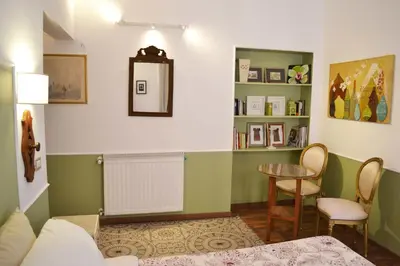a living room with a table and chairs in a room at Babbo Guest House in Rome