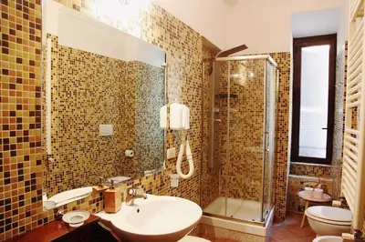 a bathroom with a sink and a shower and a toilet at Trastevere Dream House in Rome