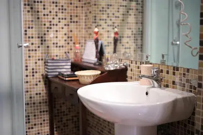 a bathroom with a sink and a mirror at Trastevere Dream House in Rome