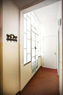 a hallway with a window with two horses on the wall at Trastevere Dream House in Rome