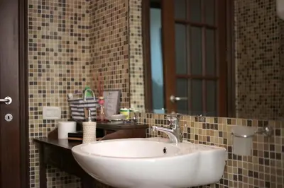 a bathroom with a white sink and a mirror at Trastevere Dream House in Rome