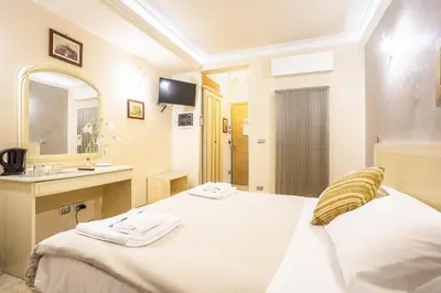 a bedroom with a bed and a sink and a mirror at Opera Theater Relais in Rome