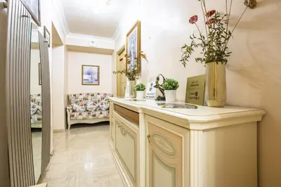 a corridor of a salon with a counter with plants at Opera Theater Relais in Rome