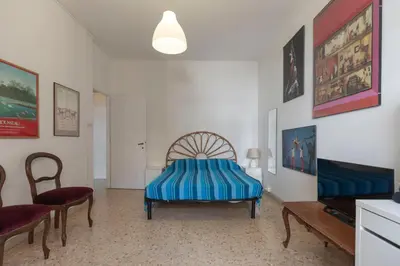 a bedroom with a bed and a table and chairs at Casa Lilly, appartamento luminosissimo a Roma in Rome