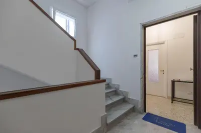 a hallway with stairs and a sliding glass door at Casa Lilly, appartamento luminosissimo a Roma in Rome