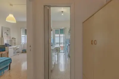 a hallway with a door leading to a living room at Casa Lilly, appartamento luminosissimo a Roma in Rome