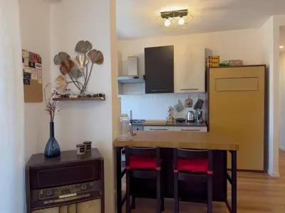 a kitchen with a table and chairs and a refrigerator at Appartamento con vista Vaticano in Rome