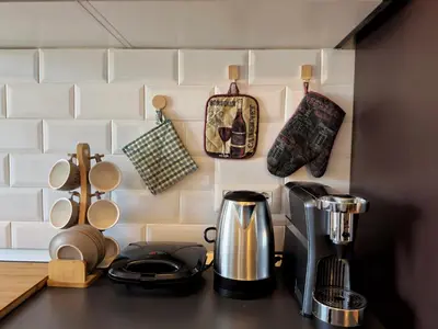 a kitchen counter with a coffee maker and cups at Appartamento con vista Vaticano in Rome