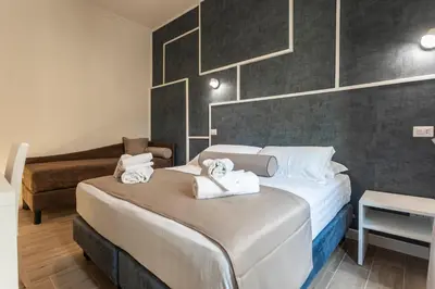 a bedroom with a large bed with towels on it at Flat 285 La Suite in Rome