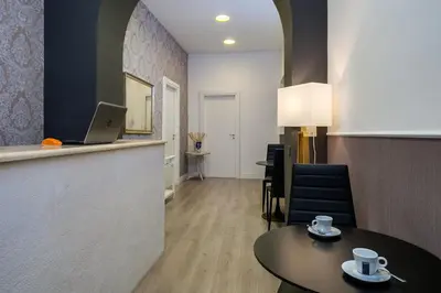 a room with a table and a laptop on a counter at Flat 285 La Suite in Rome